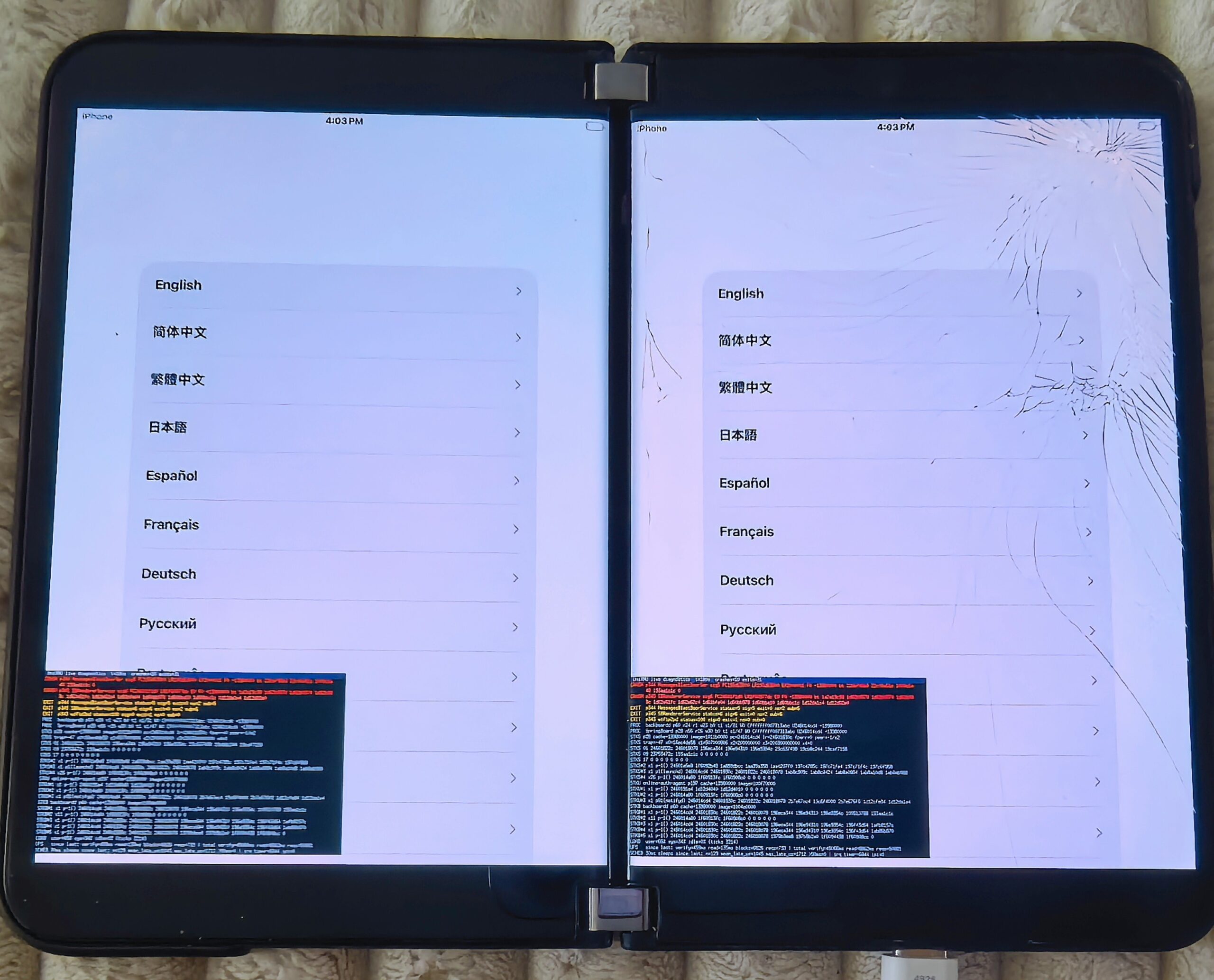 The iOS 26 language picker on both Surface Duo 2 screens, with the boot log overlaid