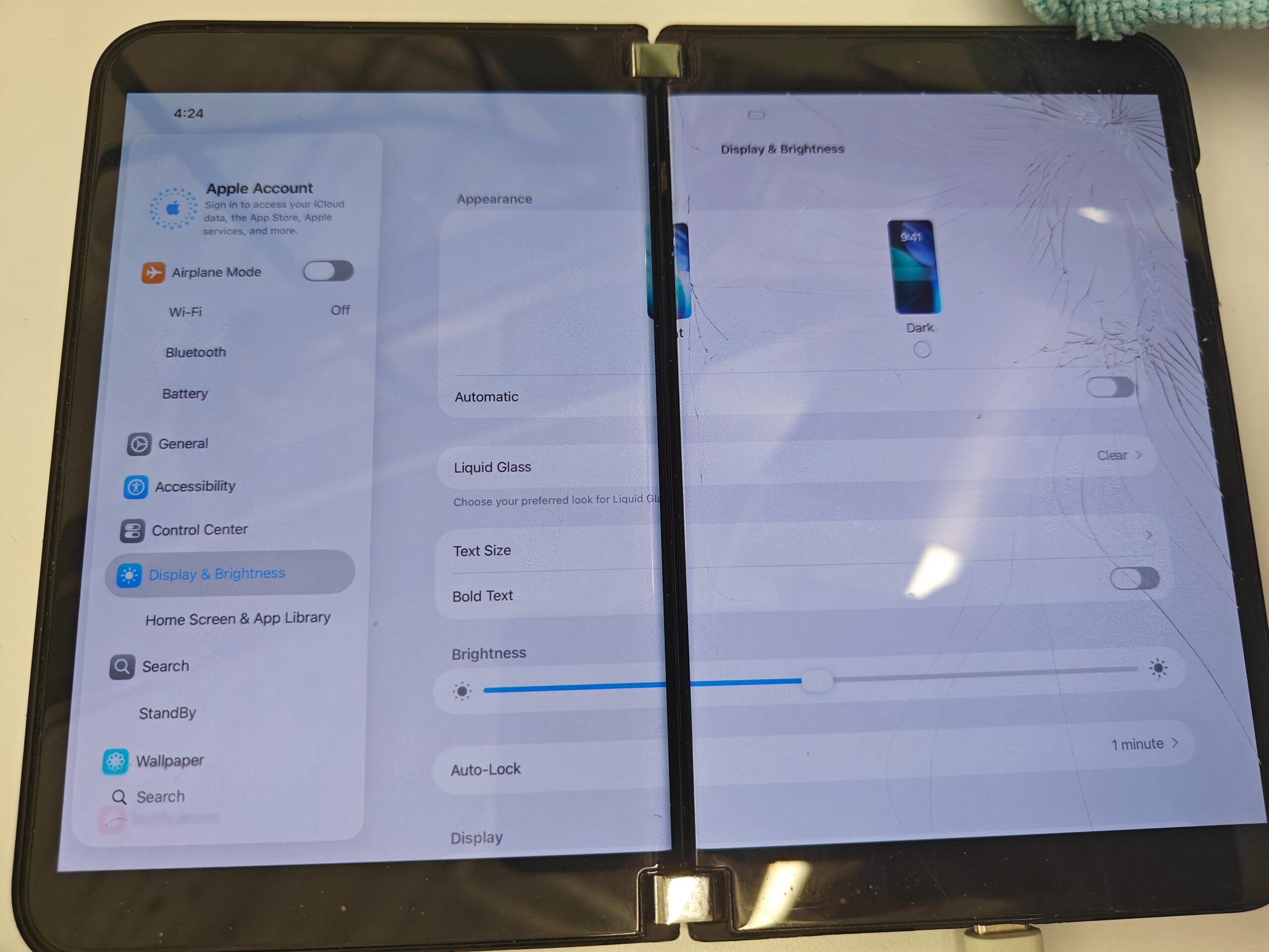 iOS 26 Settings with Liquid Glass spans both Surface Duo 2 screens